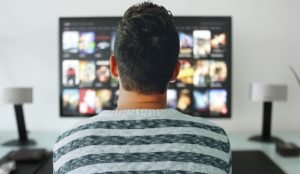 Backview of man watching TV